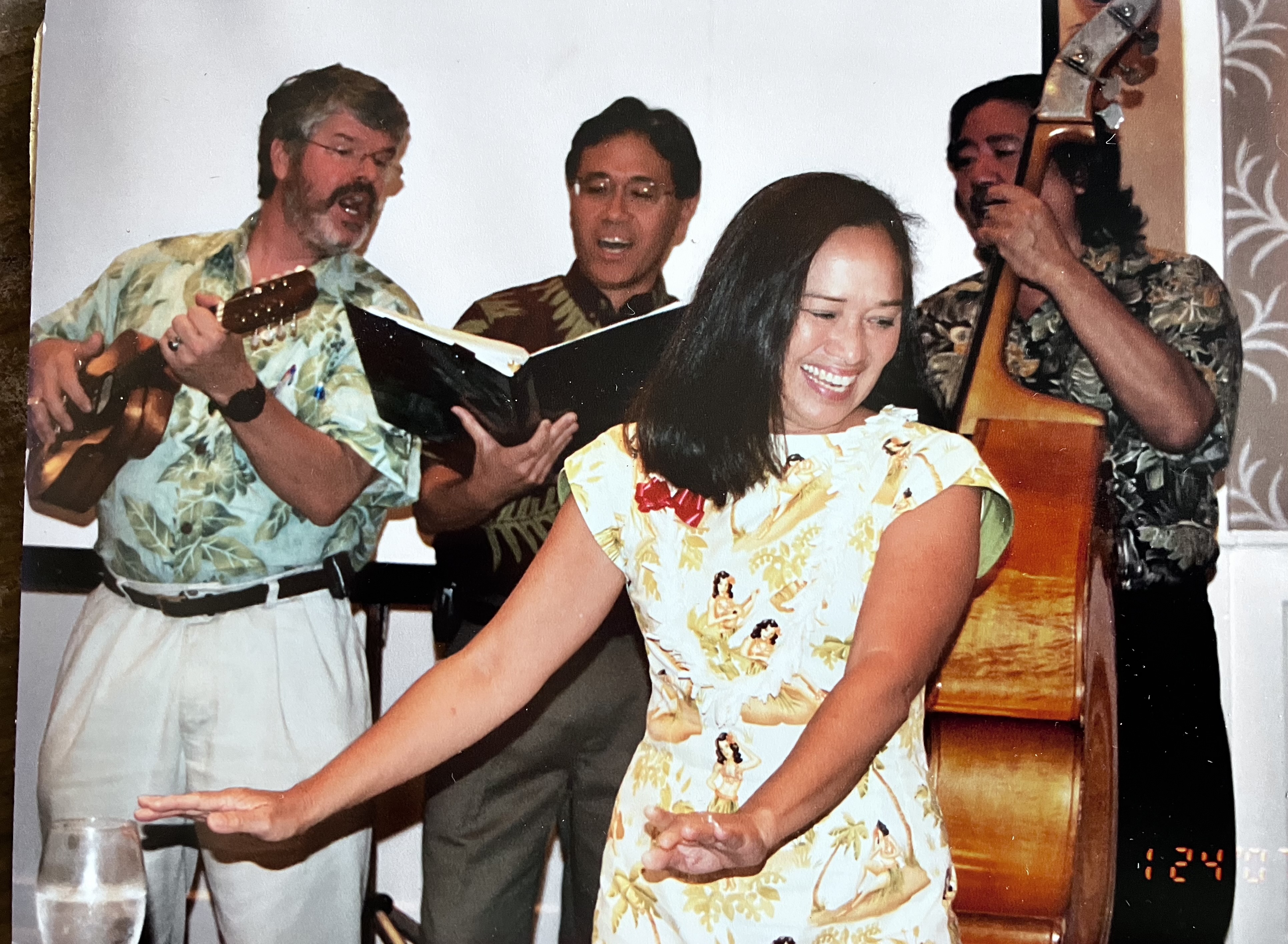 Mele Look hula with 3 musicians singing and performing in the background.